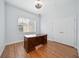 Well-lit office space featuring wood floors, a large desk, and a window at 2333 Pinehurst Ct, Davenport, FL 33837