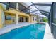 Inviting in-ground pool and spa surrounded by a screened enclosure and a spacious patio at 2333 Pinehurst Ct, Davenport, FL 33837