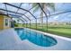 Sparkling in-ground pool and spa with a screen enclosure and a serene backyard view at 2333 Pinehurst Ct, Davenport, FL 33837