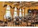 Elegant restaurant with large windows, coffered ceilings, and a fully stocked bar, creating a luxurious dining experience at 2333 Pinehurst Ct, Davenport, FL 33837