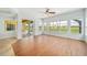 Bright sunroom with wood-style tile flooring and large windows overlooking the backyard at 2333 Pinehurst Ct, Davenport, FL 33837