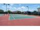 A pair of pristine tennis courts is shown with professional netting and lighting for daytime or nighttime matches at 2333 Pinehurst Ct, Davenport, FL 33837