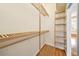 Bright walk-in closet featuring custom shelving and a spacious layout at 2333 Pinehurst Ct, Davenport, FL 33837