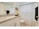 Well-lit bathroom featuring a granite vanity top, stylish decor, and a shower-tub combination at 2743 N Poinciana Blvd # 55, Kissimmee, FL 34746