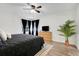This bedroom offers a calm, relaxing space, a light-colored area rug, and an indoor plant near the window at 2743 N Poinciana Blvd # 55, Kissimmee, FL 34746