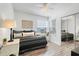 Cozy bedroom with a mirrored closet, ceiling fan, and a bright window with a lovely view at 2743 N Poinciana Blvd # 55, Kissimmee, FL 34746
