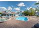 Inviting community pool and hot tub area with lounge chairs on a sunny day at 2743 N Poinciana Blvd # 55, Kissimmee, FL 34746