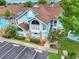 Aerial view of charming blue condo buildings with well-maintained landscaping and parking spaces at 2743 N Poinciana Blvd # 55, Kissimmee, FL 34746