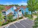 Charming condo featuring vibrant blue exteriors, well-maintained landscaping, and convenient parking at 2743 N Poinciana Blvd # 55, Kissimmee, FL 34746