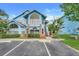 Charming blue two-story home featuring arched windows, brick accents and a cozy upstairs entrance at 2743 N Poinciana Blvd # 55, Kissimmee, FL 34746