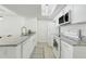 Well-lit kitchen features white cabinets, granite countertops, stainless appliances and tile flooring at 2743 N Poinciana Blvd # 55, Kissimmee, FL 34746