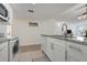 Bright kitchen with white cabinets, granite countertops, and stainless steel appliances offers a clean aesthetic at 2743 N Poinciana Blvd # 55, Kissimmee, FL 34746