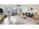 Spacious living room with a large arched window, stylish decor, and modern ceiling fan at 2743 N Poinciana Blvd # 55, Kissimmee, FL 34746