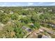 Aerial view showing house surrounded by lush green trees in neighborhood at 304 W 24Th St, Sanford, FL 32771