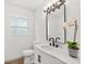 Modern bathroom featuring a marble vanity, black faucet, a decorative mirror, and an orchid at 304 W 24Th St, Sanford, FL 32771