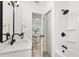 Modern bathroom featuring sleek white fixtures, a shower with dark hardware, and an elegant design at 304 W 24Th St, Sanford, FL 32771