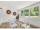 Bright dining room with a glass table and a large window view into the lush backyard at 304 W 24Th St, Sanford, FL 32771