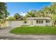 Charming single-story home featuring a lush green lawn, bright green shutters, and a fresh white exterior at 304 W 24Th St, Sanford, FL 32771
