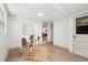 Bright office space with modern decor, wood-look floors, and a glass-topped desk with a chair at 304 W 24Th St, Sanford, FL 32771