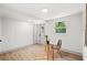 Bright and airy office space features a glass desk, modern chair, and wood-look flooring at 304 W 24Th St, Sanford, FL 32771