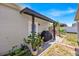 Charming covered back patio with seating and a grill, perfect for outdoor entertaining at 3193 Whispering Trails Ave, Winter Haven, FL 33884