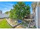 Lush backyard garden featuring mature trees and a storage shed at 3193 Whispering Trails Ave, Winter Haven, FL 33884