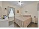 Cozy bedroom with a comfortable bed, dresser, and window offering natural light at 3193 Whispering Trails Ave, Winter Haven, FL 33884