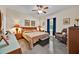 Comfortable bedroom featuring a wooden headboard, recliner, and accent lamps for cozy living at 3193 Whispering Trails Ave, Winter Haven, FL 33884