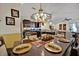 This dining room features an elegant chandelier and leads into the spacious kitchen, great for hosting at 3193 Whispering Trails Ave, Winter Haven, FL 33884