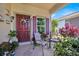 Inviting front porch with seating area, decorated with plants and a decorative wreath at 3193 Whispering Trails Ave, Winter Haven, FL 33884