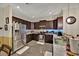 Well-equipped kitchen with granite countertops, stainless steel appliances, and dark wood cabinets at 3193 Whispering Trails Ave, Winter Haven, FL 33884