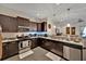 Modern kitchen with stainless steel appliances, dark cabinetry, and a view into the living room at 3193 Whispering Trails Ave, Winter Haven, FL 33884