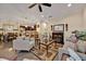 Open-concept living room with cozy furniture, a fireplace, and views into the kitchen and dining areas at 3193 Whispering Trails Ave, Winter Haven, FL 33884