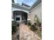 Inviting front entrance with beautiful tiled walkway and well-manicured landscaping at 3244 River Branch Cir, Kissimmee, FL 34741