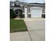 Charming single-Gathering home featuring a well-maintained lawn and attached two-car garage at 3244 River Branch Cir, Kissimmee, FL 34741