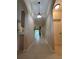 Hallway featuring open floor plan, tiled flooring, and ample natural light at 3244 River Branch Cir, Kissimmee, FL 34741