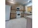 Well-lit kitchen featuring white appliances and plenty of cabinet storage at 3244 River Branch Cir, Kissimmee, FL 34741
