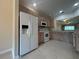 Bright kitchen with white appliances and wooden cabinets and tile floors at 3244 River Branch Cir, Kissimmee, FL 34741