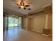Bright living room with tile flooring, ceiling fan and sliding doors to patio at 3244 River Branch Cir, Kissimmee, FL 34741