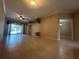 Spacious living room features tile flooring and a sliding glass door leading to an outdoor area at 3244 River Branch Cir, Kissimmee, FL 34741