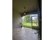Relax on the tiled patio with views of the lush, green backyard beyond the screened enclosure at 3244 River Branch Cir, Kissimmee, FL 34741