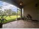 Screened patio with tiled floor and hanging lights, offering views of the spacious backyard at 3244 River Branch Cir, Kissimmee, FL 34741