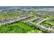 Aerial shot showcases houses in the community with lush green grass, trees, and lakes nearby at 328 Toldedo Rd, Davenport, FL 33837