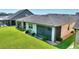 Aerial view of the back of the home with green space, screened in patio, and stone landscaping at 328 Toldedo Rd, Davenport, FL 33837