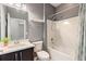 Clean bathroom with combination tub and shower, vanity, and neutral decor at 328 Toldedo Rd, Davenport, FL 33837