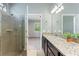 Bathroom with tiled shower, vanity with granite top, and natural light at 328 Toldedo Rd, Davenport, FL 33837