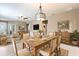 Open-concept dining area with wood table, chandelier, and coordinated decor at 328 Toldedo Rd, Davenport, FL 33837