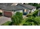 Charming single-story home featuring a well-manicured lawn, a two-car garage, and a covered front porch with seating at 328 Toldedo Rd, Davenport, FL 33837