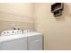 Practical laundry room includes a side-by-side washer and dryer set, plus wire shelving at 328 Toldedo Rd, Davenport, FL 33837