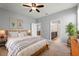 Bright bedroom featuring a ceiling fan, ensuite bath access, and comfortable decor at 328 Toldedo Rd, Davenport, FL 33837